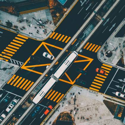 Dynamic Aerial Shot Capturing A Busy Urban Intersection In Kuala Lumpur With Vibrant Traffic And Pedestrians.