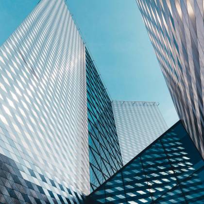 Futuristic Skyscrapers In Vilnius With Reflective Geometric Facades Under A Clear Sky.