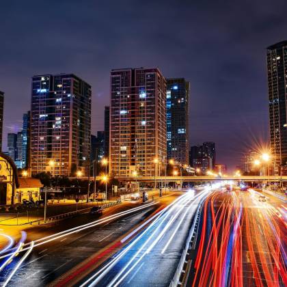 Vibrant Long Exposure Night Cityscape In Beijing Showcasing Urban Lights And Skyscrapers.