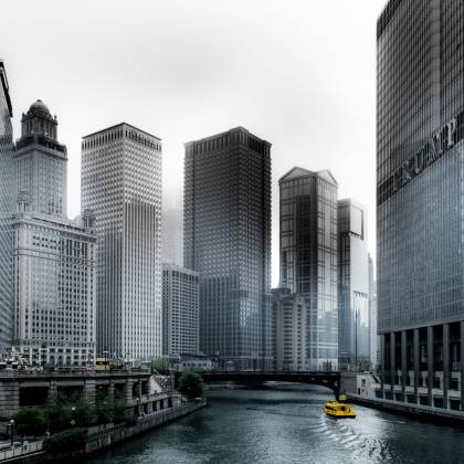 Stunning View Of Chicago's Skyscrapers Along The River With A Yellow Water Taxi.