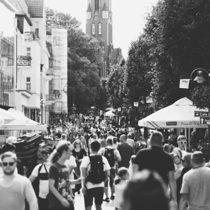 A Black And White Photo Capturing A Busy Street Filled With People In Sopot, Poland During The Day.