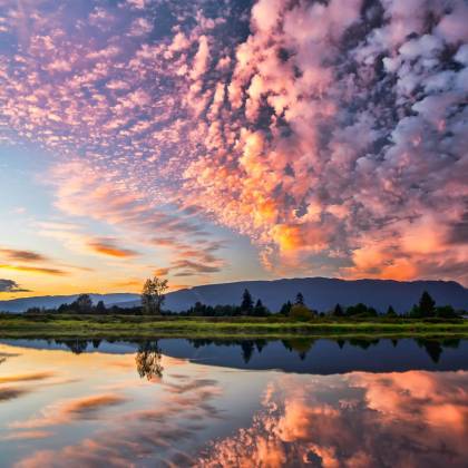 Captivating Sunset With Vibrant Clouds And Serene Reflections Over Pitt Meadows, BC.