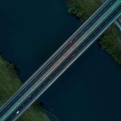 Drone Shot Capturing A Bridge Over A River In Leonay, NSW, Showcasing Transportation And Nature.