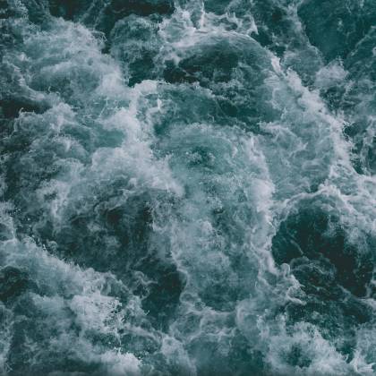 Powerful Ocean Waves Captured From Above, Showcasing The Dynamic Movement And Blue Hues Of The Sea.