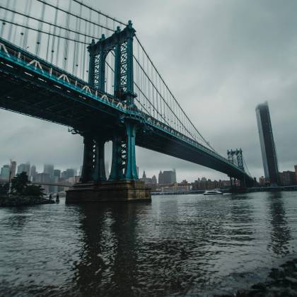 A Cloudy Day View Of The Iconic Manhattan Bridge Spanning The East River In New York City.