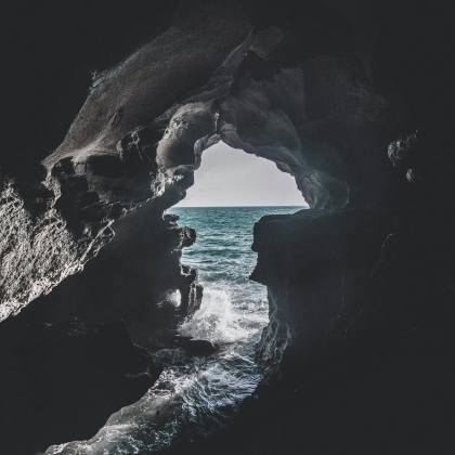 Stunning Ocean View From A Cave In Morocco, Showcasing The Play Of Light And Shadow.