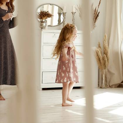 Charming Indoor Scene Of A Mother And Daughter Enjoying A Sunny Day In A Stylish, Airy Room.