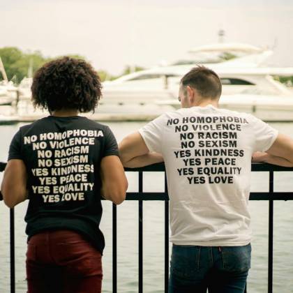 Two Men In Statement Shirts Promoting Love And Equality By A Marina In Chicago.