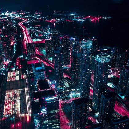 Explore The Dazzling Nightscape Of Toronto's Illuminated Skyline From Above, Showcasing Vibrant Urban Life.