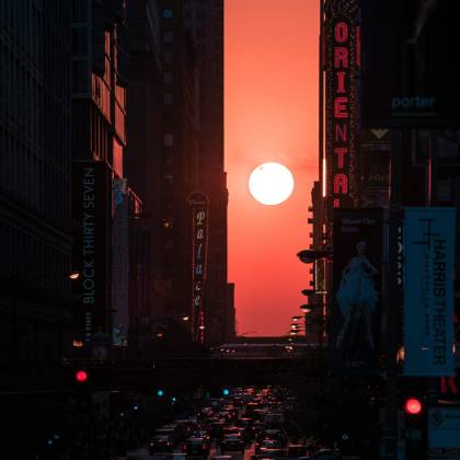 A Breathtaking View Of The Sunset Framed By Skyscrapers In Downtown Chicago, Capturing The Vibrant City Life.