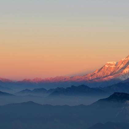 A Breathtaking View Of The Himalayan Mountains At Sunrise, Showcasing The Majestic Peaks And Serene Atmosphere.