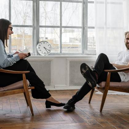 Counselor And Client In A Positive Therapy Session In A Well Lit Room.