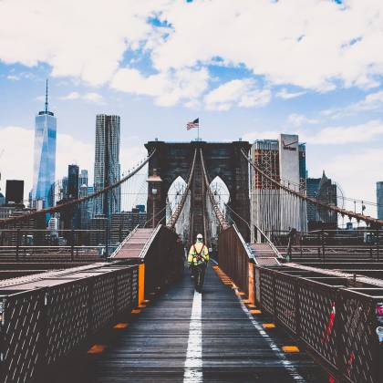 Iconic Brooklyn Bridge View With New York City Skyline And Construction Worker.