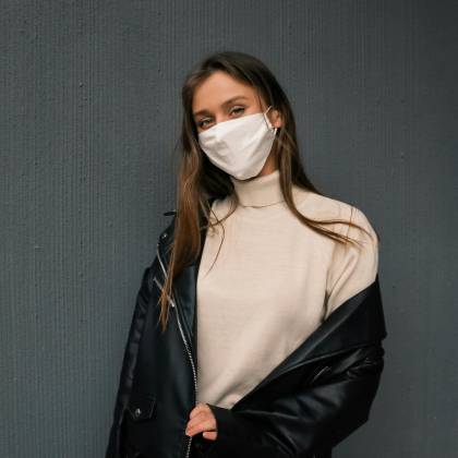 Portrait Of A Woman Wearing A Face Mask And Black Leather Jacket.