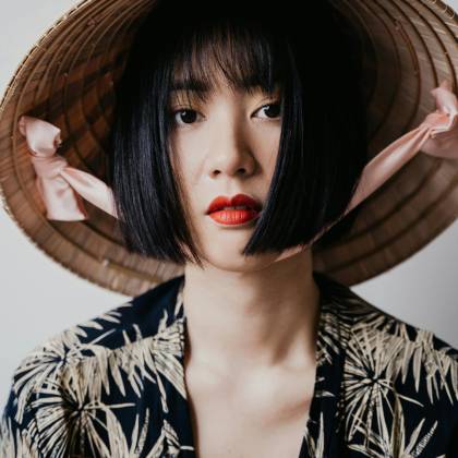 Close Up Portrait Of A Woman With Red Lips And A Traditional Hat.