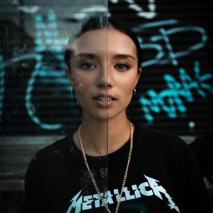 Dramatic Portrait Of A Young Woman With Graffiti, Showcasing Urban Style.