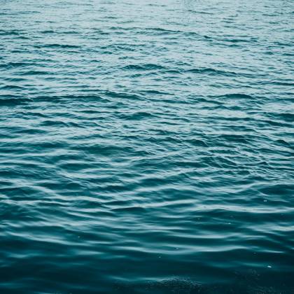 A Serene View Of Blue Ocean Waves Creating A Calming Texture On The Water's Surface.