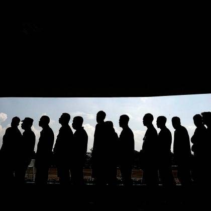 Silhouettes Of People In Line Under A Shaded Canopy, Highlighting Social Interaction And Society.