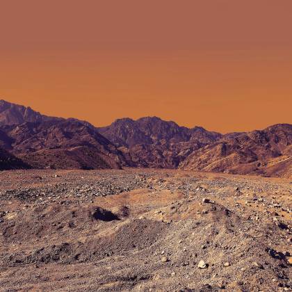 Stunning Landscape Of South Sinai's Rocky Desert Under A Vibrant Orange Sky.
