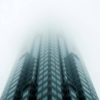 Low Angle View Of A Modern Skyscraper Disappearing Into Fog In Atlanta, GA.